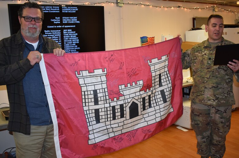 The Hawk is presented with the USACE flag, signed by peers and team members from the Afghanistan District as the Deputy Commander, Lieutenant Michael Harding reads the symbolism of the flag that was flown at Bagram on this date.