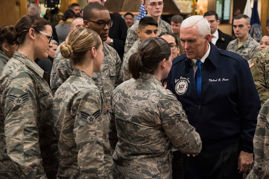The vice president shakes hands with service members.