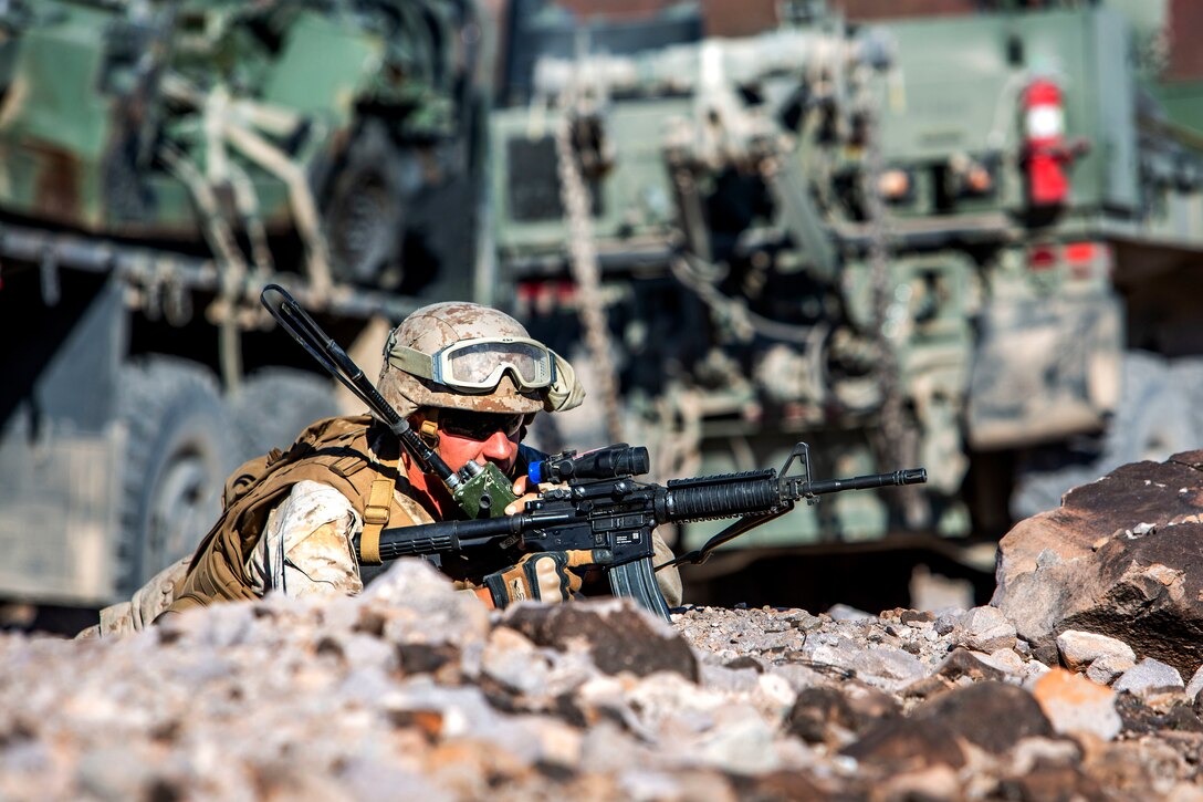 A soldier on the ground holding a weapon