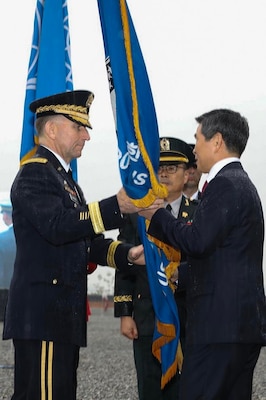 Jeon Kyeog-Doo, Minister of National Defense, Republic of Korea and Gen. Robert B. Abrams participate in the passing of the Combined Forces Command colors with the Ground Component Command Senior Enlisted Advisor, Command Sgt. Maj. Kim, Joo sik.