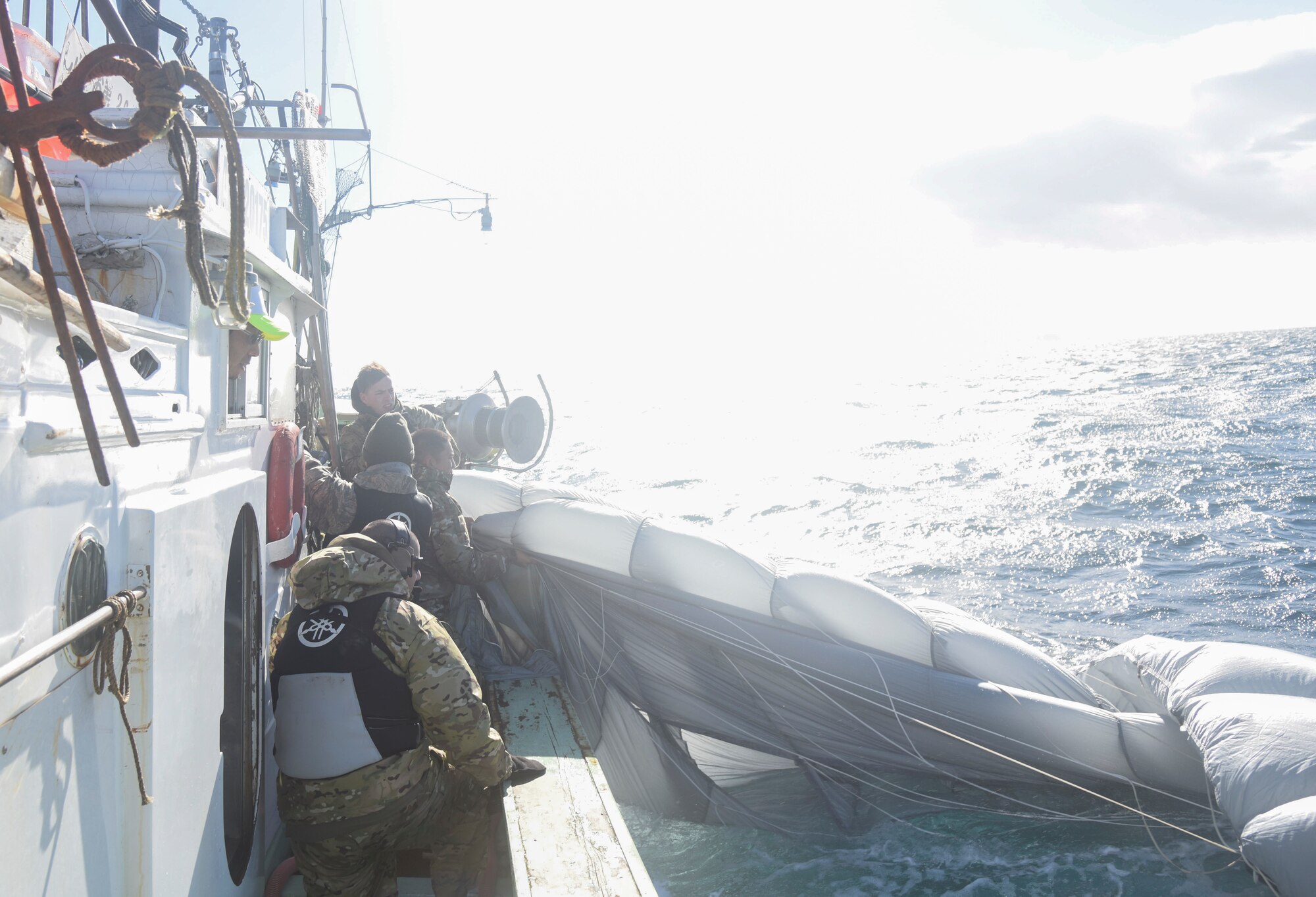 U.S. Air Force Airmen with the 31st Rescue Squadron from Kadena Air Base, Japan, pull in a parachute canopy during a combat search and rescue training as part of exercise Keen Sword 19, near Misawa Air Base, Japan, Oct. 31, 2018. The team recovered thousands of dollars in assets, saving military funding. Executing a CSAR training mission was one part of KS19, who had approximately 10,000 participate in the joint, bilateral training. (U.S. Air Force photo by Senior Airman Sadie Colbert)