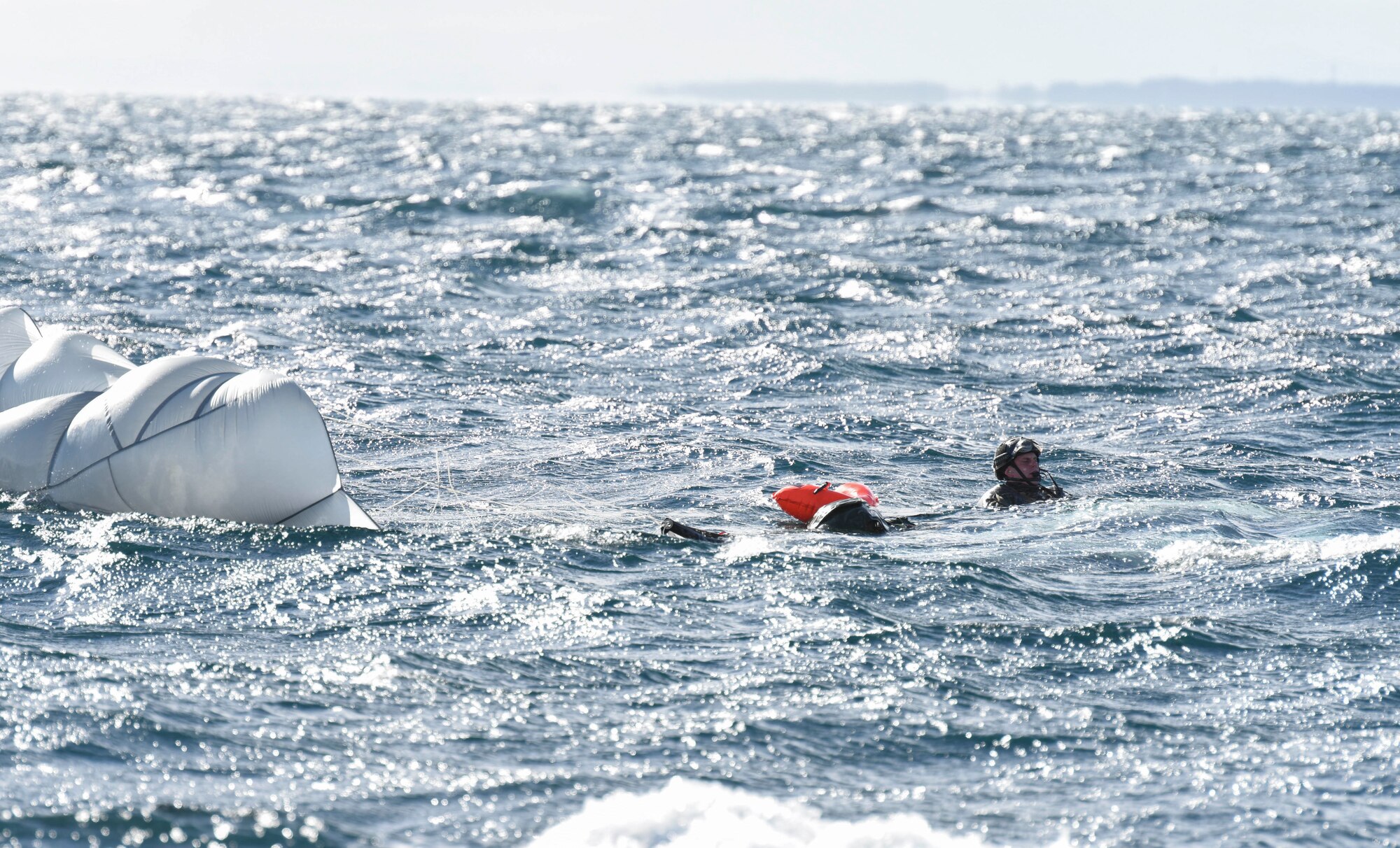 U.S. Air Force Capt. John Krzyminski, a 31st Rescue Squadron combat rescue officer from Kadena Air Base, Japan, resurfaces from the water after jumping during a combat search and rescue training mission as part of exercise Keen Sword 19, near Misawa Air Base, Japan, Oct. 31, 2019. A team of approximately 20 personnel from the 31st RQS worked with the Japan Self-Defense Force during the CSAR training operation. The U.S. conducts exercises with its partners and allies and continues to send the most advanced military equipment to the region to help ensure the peace and stability of the Indo-Pacific region. (U.S. Air Force photo by Senior Airman Sadie Colbert)