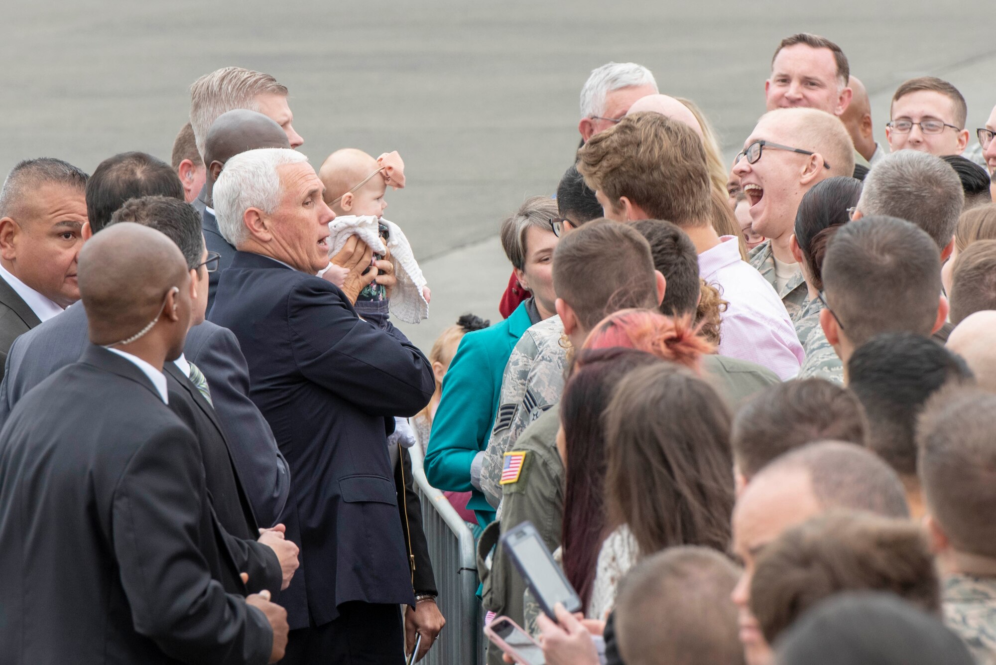 Vice President of the United States Michael R. Pence holds a baby as part of a meet and greet with service members and their families prior to departing Yokota Air Base, Japan, Nov. 13, 2018.