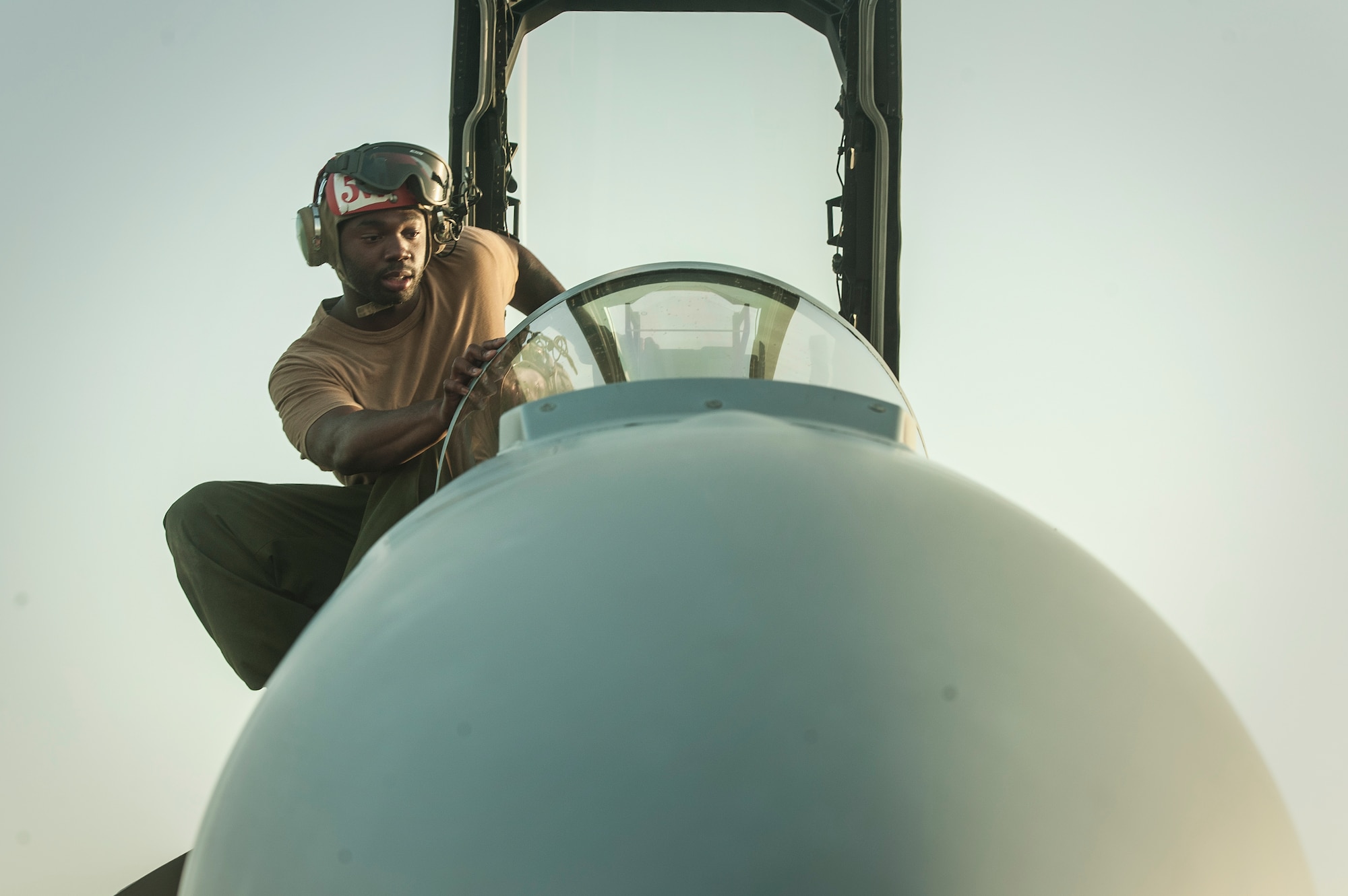 Aviation Machinist Mate 3rd Class Tareik Ellis from the Electronic Attack Squadron 135 (VAQ-135) “Black Ravens” conducts maintenance on an EA-18G Growler, Oct. 30, 2018, at Al Udeid Air Base, Qatar. The electronic warfare aircraft has electronic attack, jamming, and satellite communication capabilities as well as communication countermeasures. VAQ-135 will replace VMAQ-2, which operated EA-6B Prowlers. VAQ-135 is deployed to the U.S. 5th Fleet area of operations in support of naval operations to ensure maritime stability and security in the Central Region, connecting the Mediterranean and the Pacific through the western Indian Ocean and three strategic choke points. (U.S. Air Force photo by Tech. Sgt. Christopher Hubenthal)