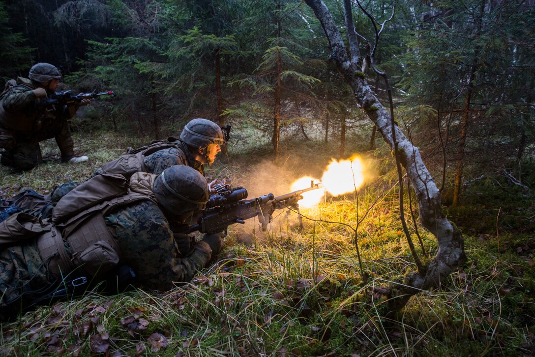 U.S. Marines Cpl Justin Droll and Lance Cpl. Stephen Luzier, Machine Gunners, with E Company, 2nd Battalion, 2nd Marine Regiment, 2nd Marine Division, assault an enemy position during exercise Trident  Juncture 18, Norway, Nov. 7, 2018. Events for Trident Juncture will provide 2nd Marine Division to train in unique environments in support of partner nations.
