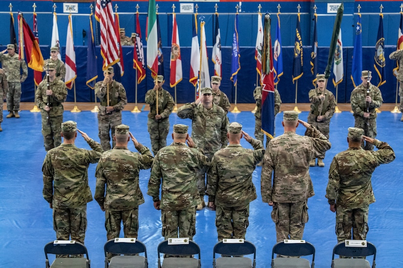 Maj. Gen. Benjamin Corell, 34th Red Bull Infantry Division commanding general and Command Sgt. Maj. Joseph Hjelmstad uncase the Division colors during a transfer of authority ceremony Nov. 12, 2018. The Minnesota National Guard unit's headquarters and headquarters battalion assumed responsibility for the Task Force Spartan mission to from the Pennsylvania National Guard's 28th Infantry Division. The 34th's HHBN is serving as a division headquarters for roughly 10,000 Soldiers conducting theater security operations in the Middle East.