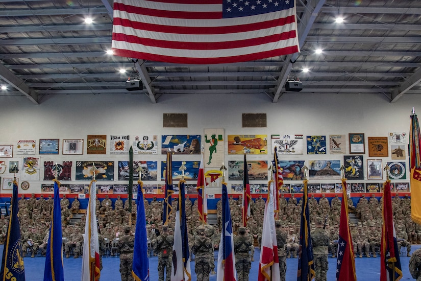 Maj. Gen. Benjamin Corell, 34th Red Bull Infantry Division commanding general and Command Sgt. Maj. Joseph Hjelmstad uncase the Division colors during a transfer of authority ceremony Nov. 12, 2018. The Minnesota National Guard unit's headquarters and headquarters battalion assumed responsibility for the Task Force Spartan mission to from the Pennsylvania National Guard's 28th Infantry Division. The 34th's HHBN is serving as a division headquarters for roughly 10,000 Soldiers conducting theater security operations in the Middle East.