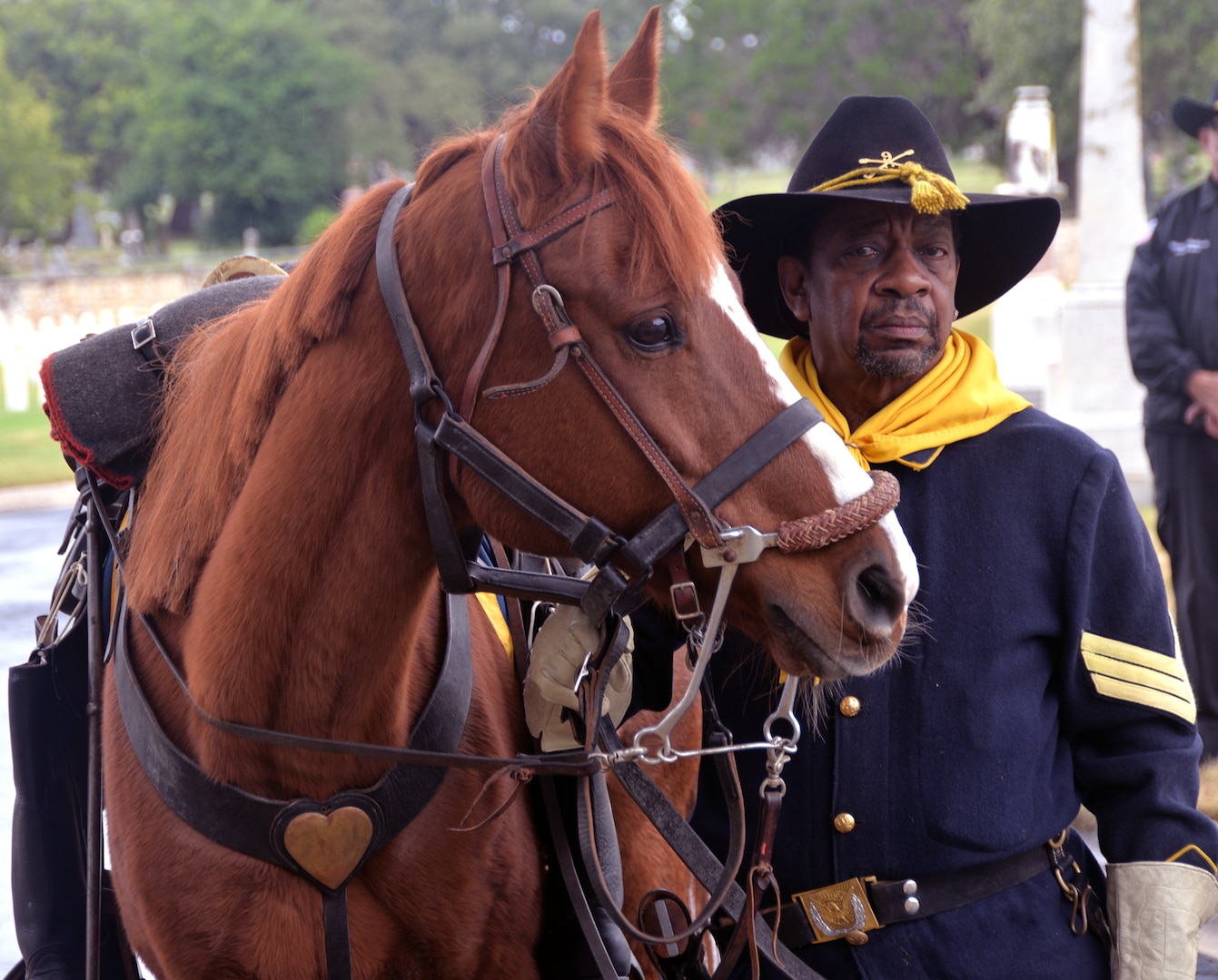 A member of the Bexar County Buffalo Soldiers stands with his mount into the San Antonio National Cemetery Nov. 11 for the annual Bexar County Buffalo Soldiers Commemorative Ceremony. Comprised of former slaves, freed men and Black Civil War veterans, the historic Buffalo Soldiers persevered through the most difficult conditions imaginable to become some of the most elite and most decorated units in the U.S. Army.