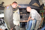 Tech. Sgt. Eric K. Ganley, 68th Airlift Squadron flight engineer, talks with Lt. Col. Terrance J. Holmes, 332nd Recruiting Squadron commander, about the flight engineer station on a C-5M Super Galaxy Nov. 8, 2018 at Joint Base San Antonio-Lackland, Texas.
