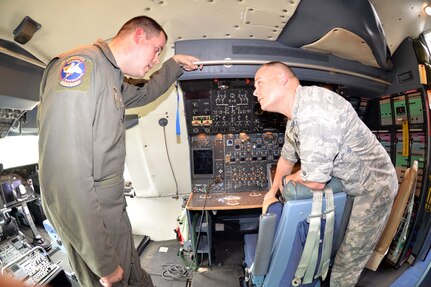 Tech. Sgt. Eric K. Ganley, 68th Airlift Squadron flight engineer, talks with Lt. Col. Terrance J. Holmes, 332nd Recruiting Squadron commander, about the flight engineer station on a C-5M Super Galaxy Nov. 8, 2018 at Joint Base San Antonio-Lackland, Texas.