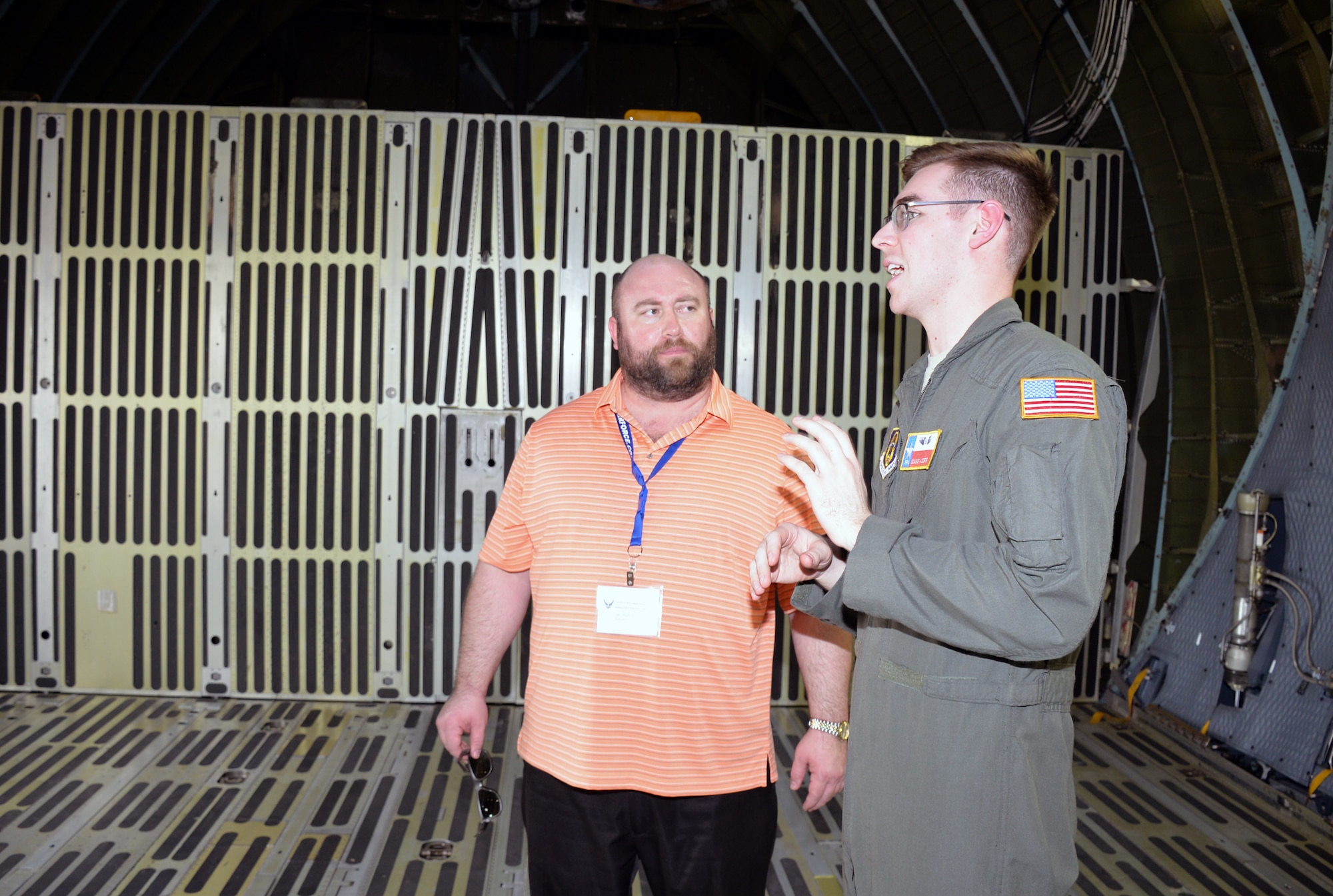 Senior Airman Blake Moore, 68th Airlift Squadron loadmaster, describes the cargo compartment of a C-5M Super Galaxy to Mark Millett, school counselor from Cincinnati, Ohio, at Joint Base San Antonio-Lackland, Texas Nov. 8, 2018.