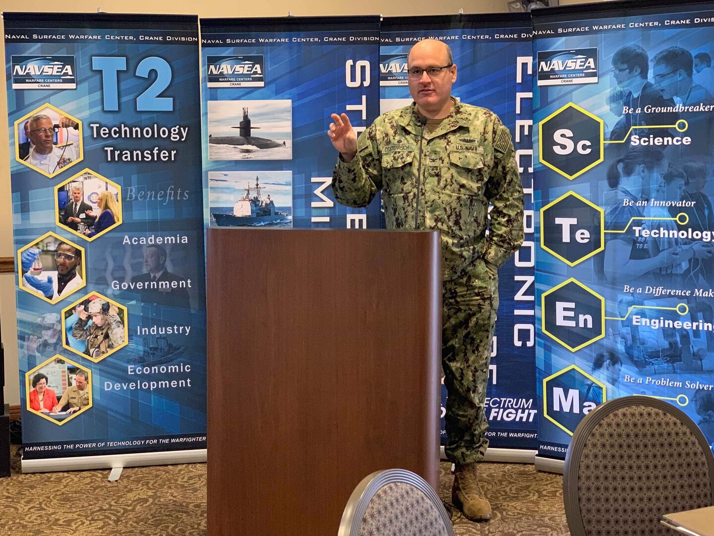 CAPT Oesterreich, NSWC Crane Commanding Officer, delivered opening remarks at the fifth annual Invention and Technology Showcase on Nov. 13. The showcase featured the intellectual property (IP) and innovations of more than 50 NSWC Crane scientists and engineers.