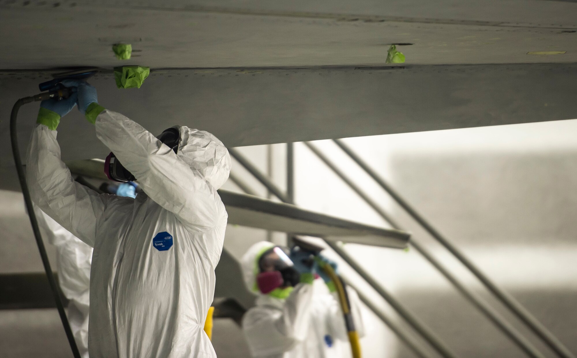 A U.S. Airman assigned to the 20th Equipment Maintenance Squadron corrosion control paint barn, sand the bottom of an F-16CM Fighting Falcon at Shaw Air Force Base, S.C., Nov. 13, 2018.