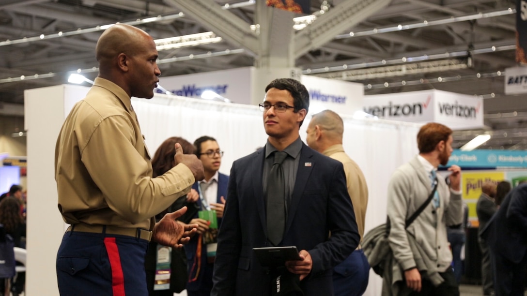 Alexander Arzon, electrcal engeginering studetn at Clemson University, speaks to Capt. Maurice Kitchens Jr. at the Society of Hispanic Professional Engineers (SHPE) 2018 National Convention in Cleveland, Nov. 9, 2018. Nearly 7,000 students, all of Hispanic heritage, attended the SHPE 2018 National Convention, which provided students an opportunity to network with the engineering community and show off their skills. (U.S. Marine Corps Photo by Cpl. Nelson Duenas)
