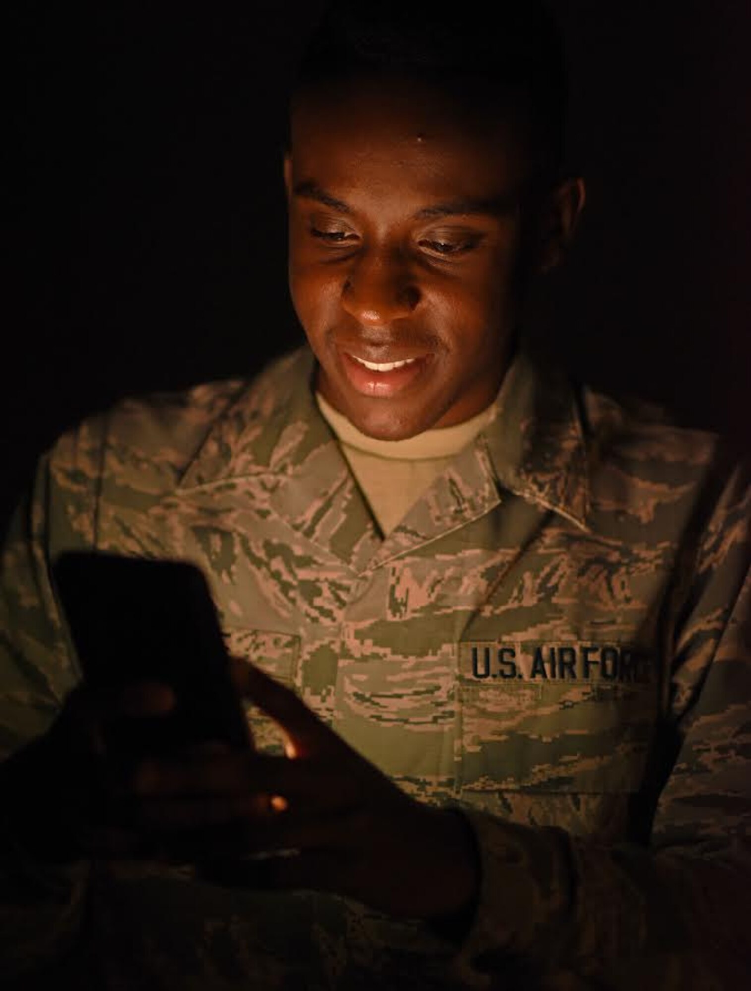 U.S. Air Force Airman 1st Class Tommy Greene, 20th Comptroller Squadron finance technician, holds up a phone to show the Shaw App at Shaw Air Force Base, S.C., Nov. 13, 2018.
