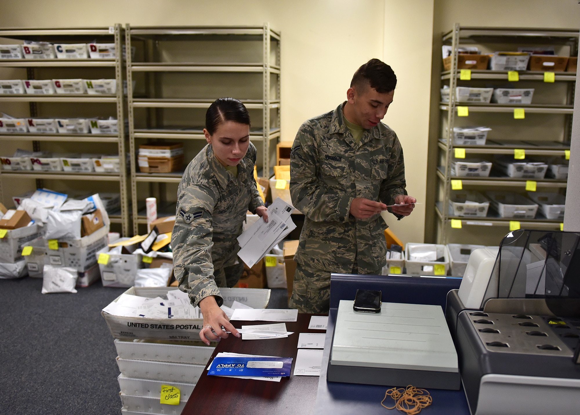 U.S. Air Force Airmen 1st Class Isabella Opichka, left, and Gerald Johnson, both 325th Force Support Squadron official mail technicians, organize mail at Tyndall Air Force Base, Fla., Nov. 12, 2018. The mail center is slated to be fully operational beginning Nov. 13. (U.S. Air Force photo by Senior Airman Isaiah J. Soliz)