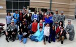 Dolph Briscoe Middle School students and Reserve Citizen Airmen with the 433rd Aeromedical Evacuation Squadron accompanied by Tech. Sgt. Melissa Proscia (left), 433rd Airlift Wing command post, and TThunder, a puppy from the Military Working Dog Program, take a moment with students after the school’s 9th annual Veterans Day ceremony in San Antonio, Texas Nov. 9, 2018.