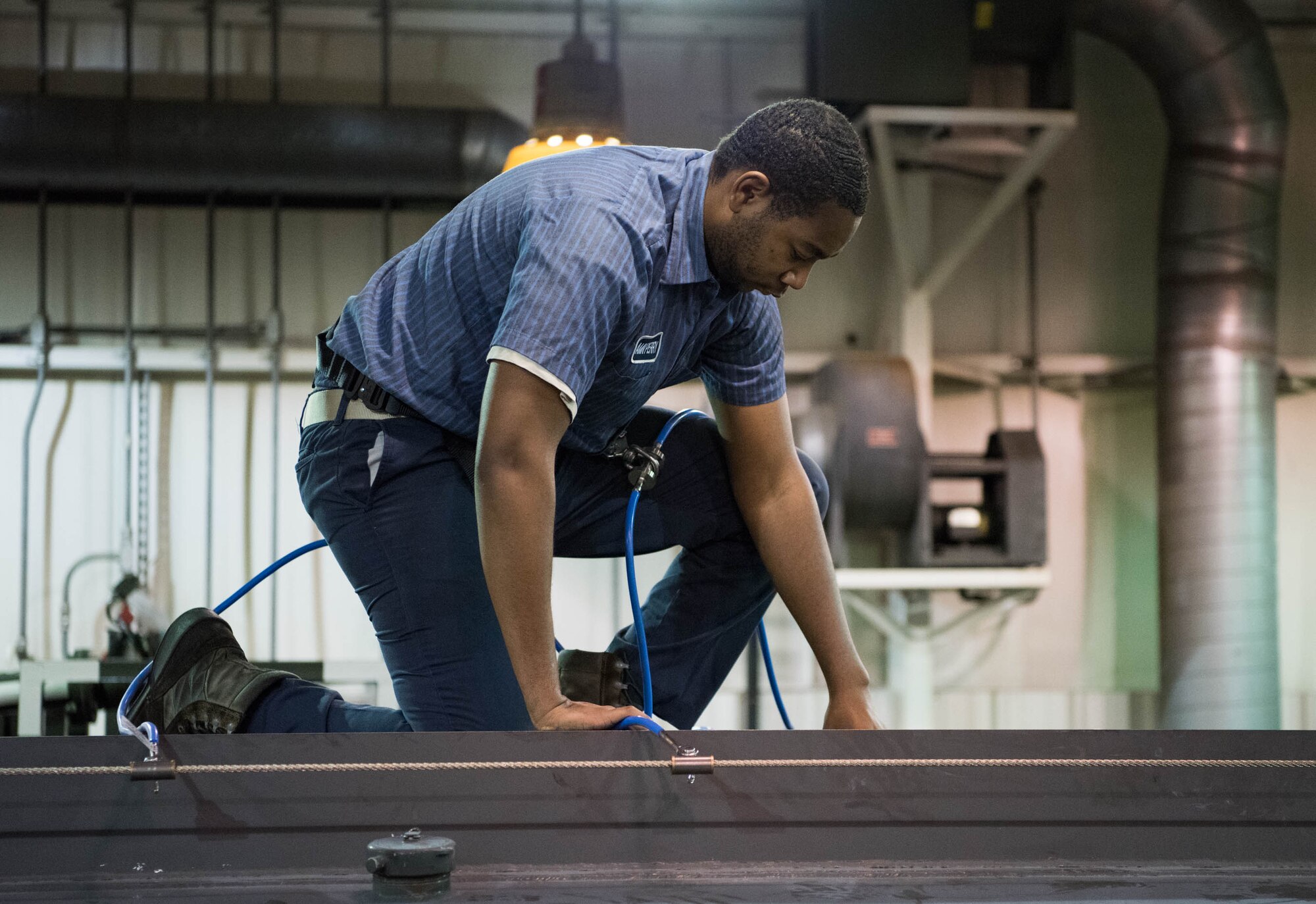 Airman 1st Class William Perry, 436th Logistics Readiness Squadron firetruck refueling maintenance journeyman, works on top of an R-11 aircraft refueling truck Nov. 6, 2018, at Dover Air Force Base, Del. Perry was safely secured on top of the vehicle using the squadron’s new fall-protection equipment designed specifically for R-11s.  (U.S. Air Force photo by Staff Sgt. Zoe Russell)