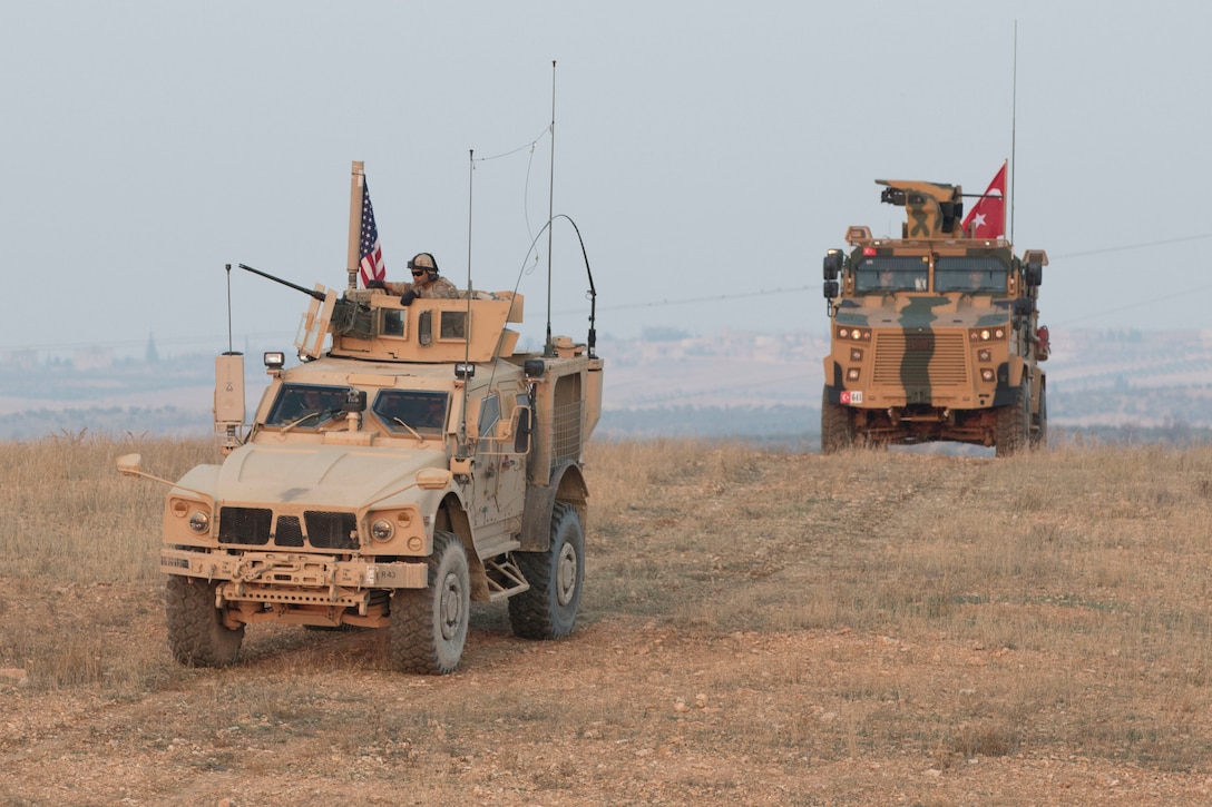 American and Turkish troops conduct a convoy during a joint patrol in Manbij, Syria.