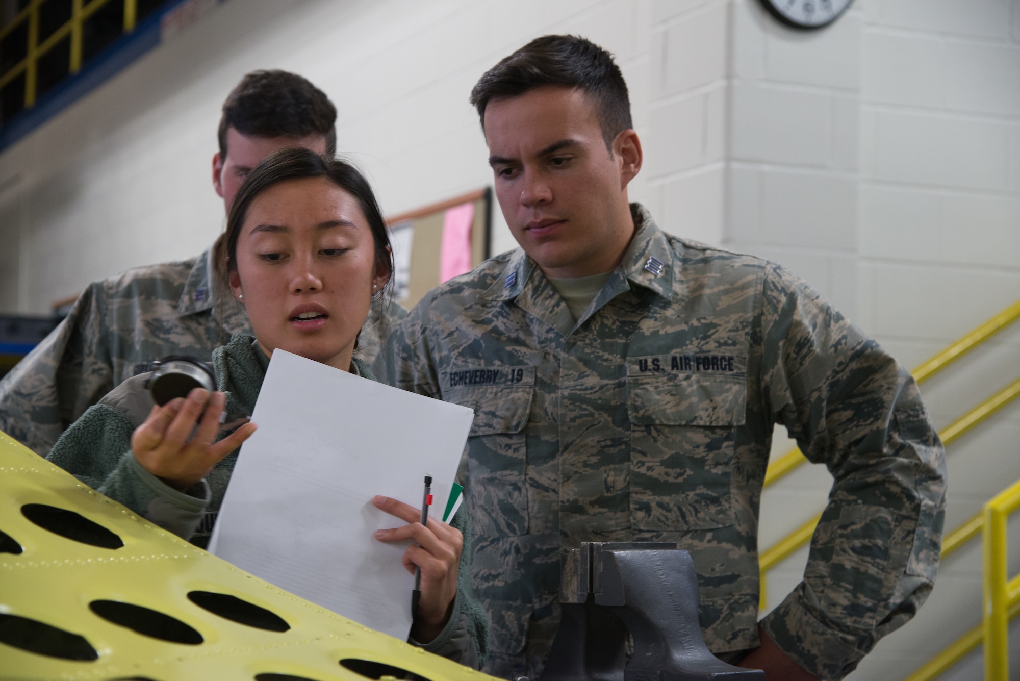 Cadets Mai-Lin Quinto and Lucas Echeverry, from the U.S. Air Force Academy, Colorado, inspect a tool designed to measure the depth of corroded pits on aircraft metals Oct. 23, 2018, at Peterson Air Force Base, Colorado.