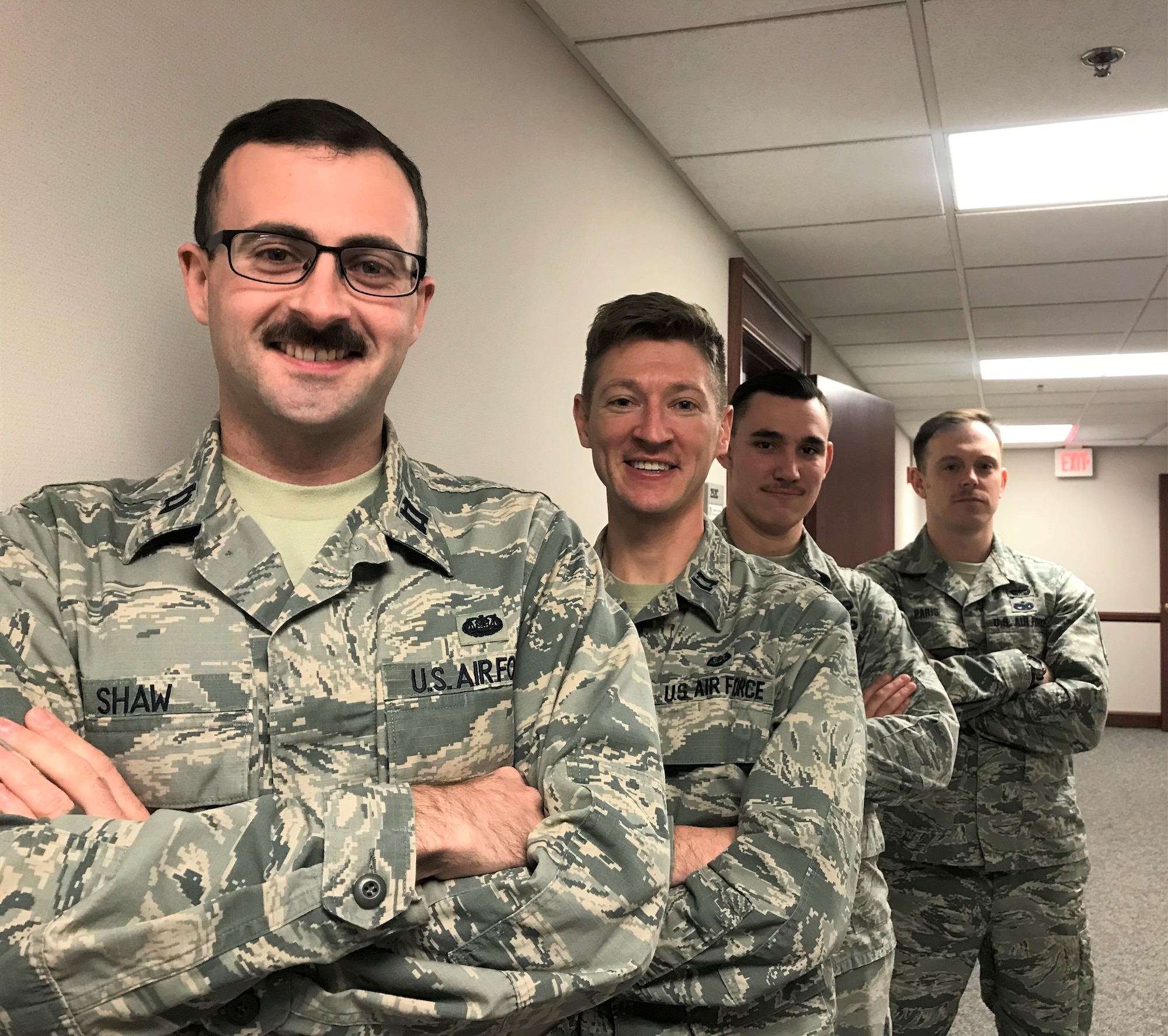 Left to right, Capt. Tim Shaw, Capt. John Lipscomb, Staff Sgt. Dakota Herndon and Tech Sgt. Matt Paris and from the 88th Air Base Wing Judge Advocates office, are growing mustaches in support of Mustache Movember. Movember is an annual event of growing mustaches during the month of November to bring awareness to men’s health issues such as prostate, testicular cancer and mental health.  (U.S. Air Force photo by Stacey Geiger)