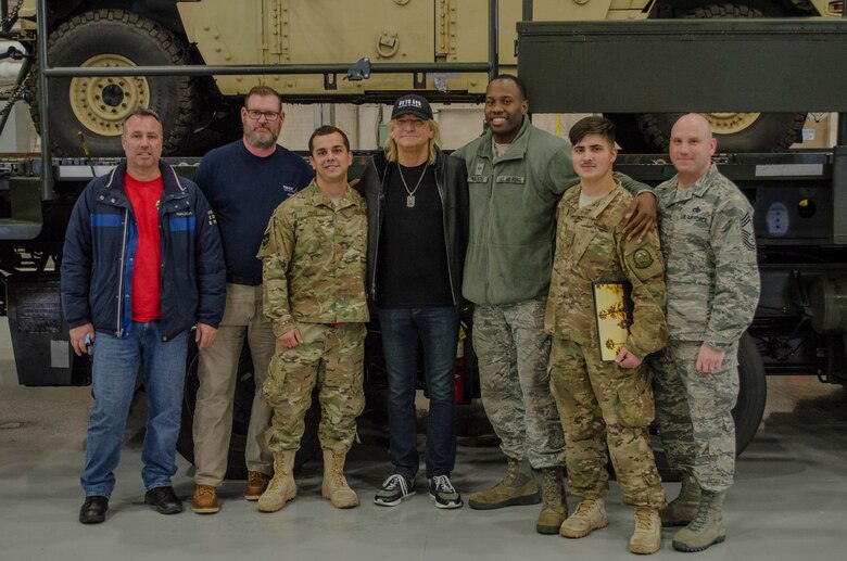 Personnel assigned to Joint Base Lewis-McChord, Wash., pose for a photograph with iconic rock n’ roll musician Joe Walsh Nov. 7, 2018. Walsh was in the area for a concert benefiting military veterans. (U.S. Air Force photo by Senior Master Sgt. Sherri Nordin)