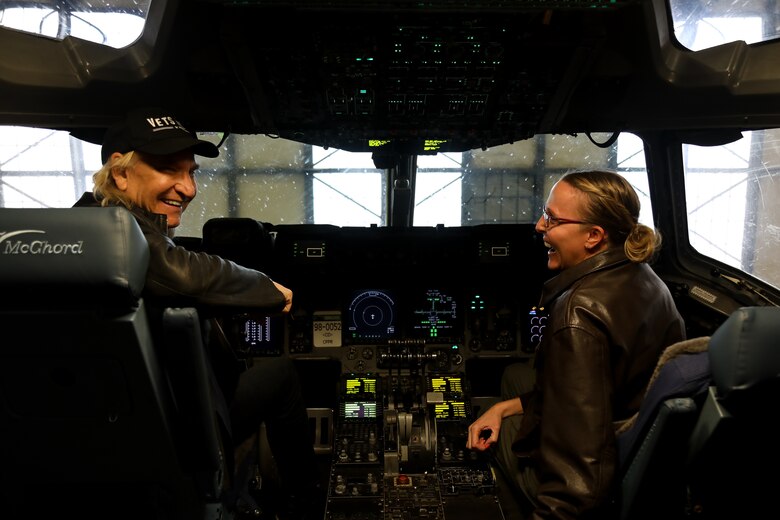 Lt. Col. Rachel Metzgar, a pilot assigned to 728 Airlift Squadron, shows Joe Walsh the flight deck of a C-17 Globemaster III on Joint Base Lewis-McChord, Wash., Nov. 7, 2018. Walsh was in the area for a concert benefiting military veterans. (U.S. Air Force photo by David L. Yost)