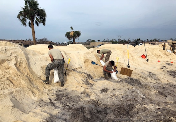 From left: Staff Sgt. Charlie Hegwer, Tech. Sgt. Skyler Shull and Airman Hunter Benson, 85th Engineering Installation Squadron, fill sandbags to place around tents in preparation of inclement weather at Tyndall Air Force Base, FL. The Airmen are part of a five-team team helping restore communication capabilities to the base after Hurricane Michael made landfall along the Florida Gulf Coast in mid-October. (U.S. Air Force courtesy photo)