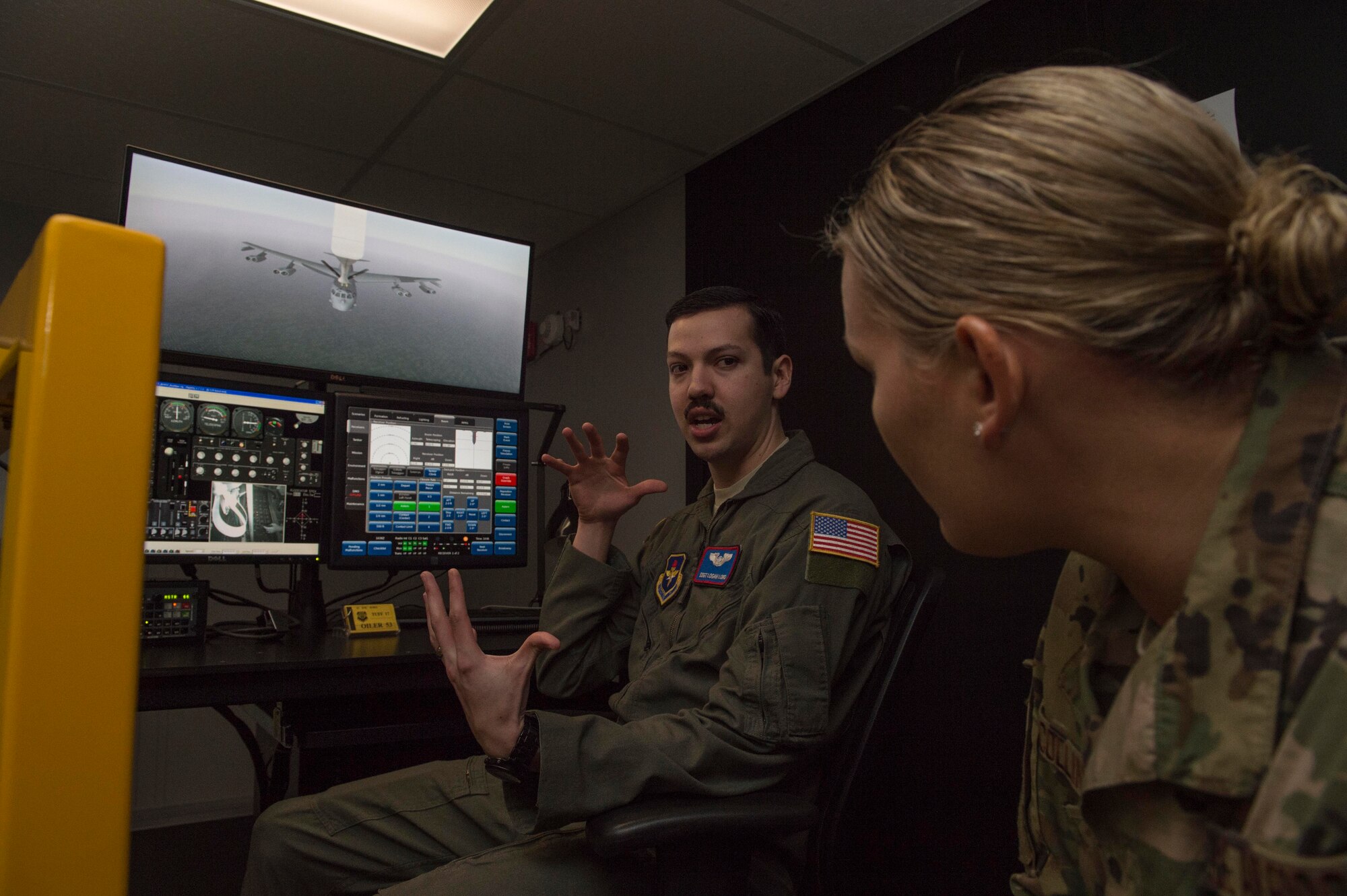 U.S. Air Force Staff Sgt. Logan Lord, a boom operator assigned to the 54th Air Refueling Squadron, explains the process of students using the KC-135 Boom Operator Weapon System Trainer simulator to U.S. Air Force Tech. Sgt. Kristie Collins, the pipeline training manager for the Air Force Personnel Center Career Enlisted Aviators assignment branch,