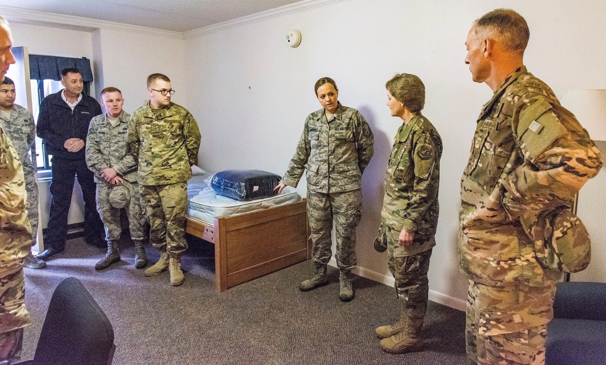 Master Sgt. Amber Lawrence, center, 436th Civil Engineer Squadron unaccompanied housing supervisor, briefs Gen. Maryanne Miller, Air Mobility Command commander, and Chief Master Sgt. Larry Williams, AMC command chief, both from Scott Air Force Base, Ill.; on typical room amenities in dormitory 401 Nov. 6, 2018, at Dover Air Force Base, Del. Lawrence briefed Miller that this particular dorm was built in 1976 and received a minor renovation in 2004. (U.S. Air Force photo by Roland Balik)