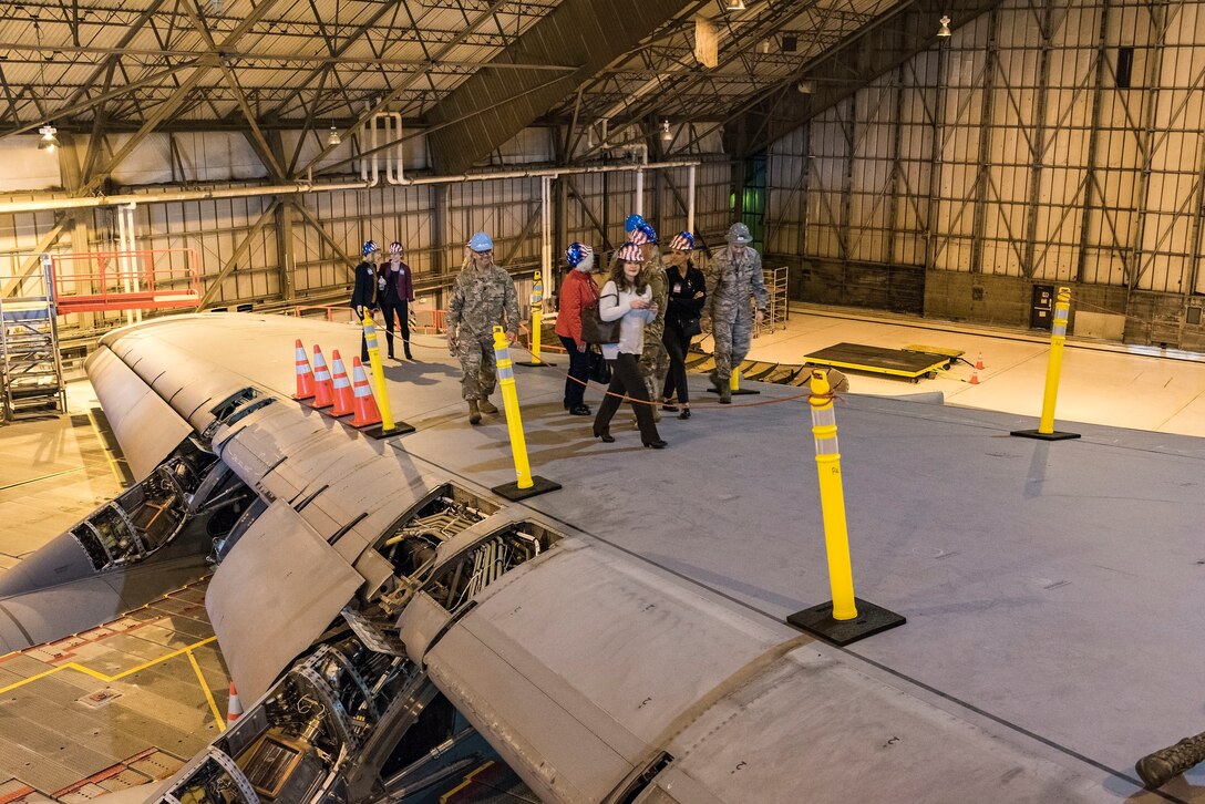 Air Mobility Command civic leaders and aircraft maintainers assigned to the 436th Maintenance Squadron walk on top of a C-5M Super Galaxy wing while undergoing a major inspection Nov. 7, 2018, in the Isochronal Inspection Dock at Dover Air Force Base, Del. Maintenance personnel gave the civic leaders a guided tour of the aircraft, inside and out, while explaining the isochronal inspection process and schedule. (U.S. Air Force photo by Roland Balik)