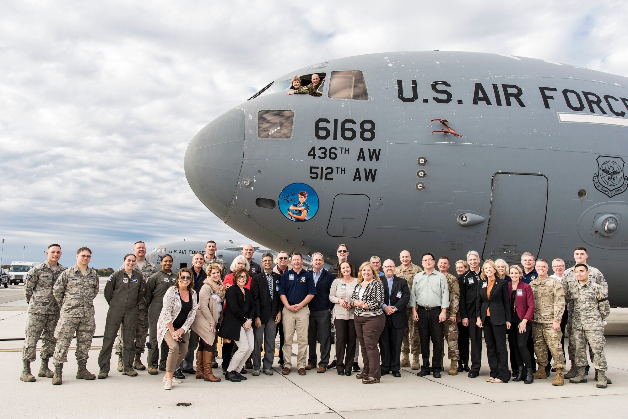 Gen. Maryanne Miller, AMC commander, and Chief Master Sgt. Larry Williams, AMC command chief, look out the pilot’s side window as AMC civic leaders and Team Dover members pose for a photo at the nose of a C-17 Globemaster III Nov. 7, 2018, at Dover Air Force Base, Del. The civic leaders visited the base for a two-day tour of various units while meeting with Team Dover Airmen to better understand Team Dover’s mission. (U.S. Air Force photo by Roland Balik)