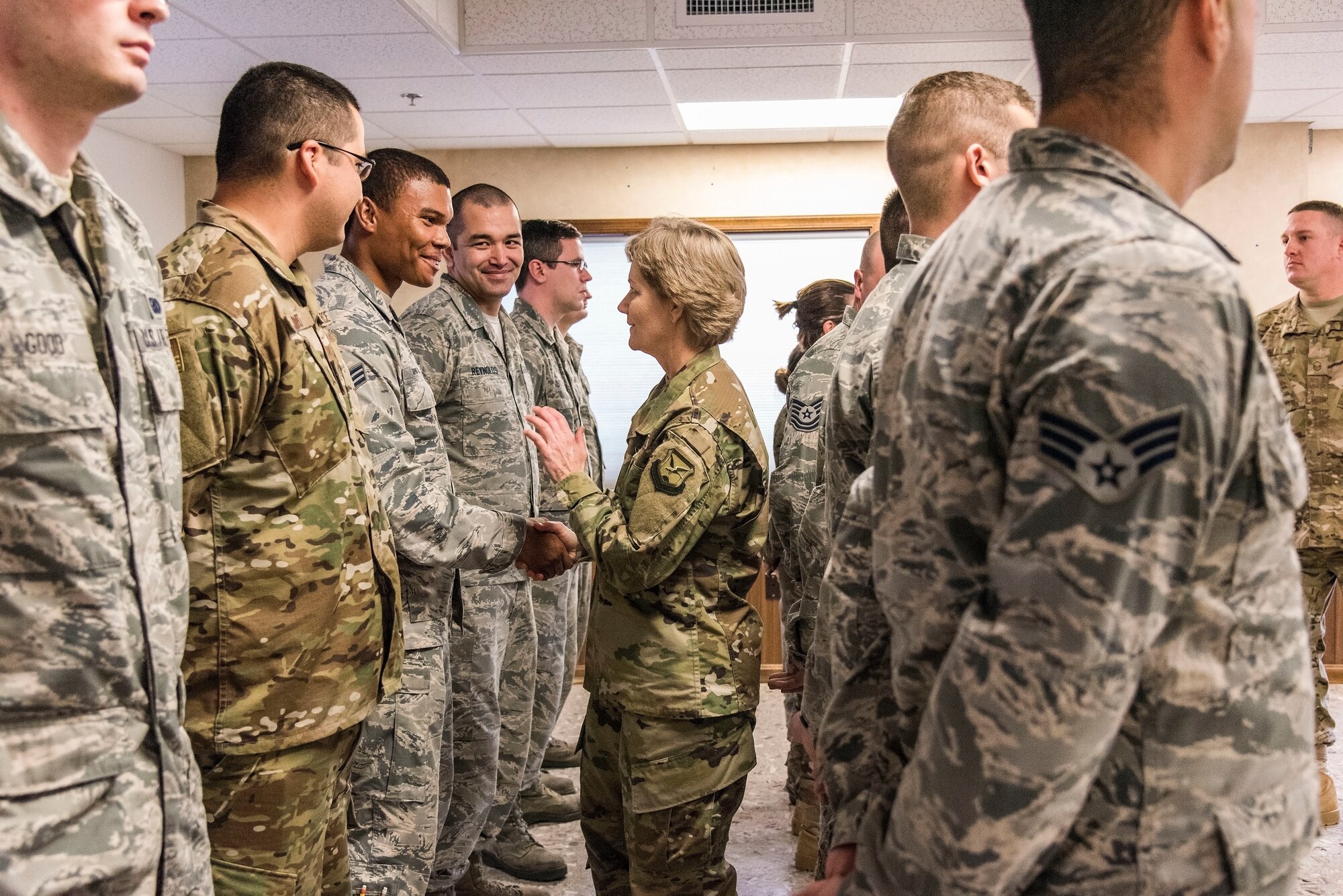 Gen. Maryanne Miller, center, Air Mobility Command commander, shakes hands with Senior Airman Alexander Tapnio-Williams, 436th Logistics Readiness Squadron fuels preventative maintenance supervisor Nov. 6, 2018, at Dover Air Force Base, Del. Miller spoke to and met with members of the 436th LRS fuels flight during her tour of the base. (U.S. Air Force photo by Roland Balik)