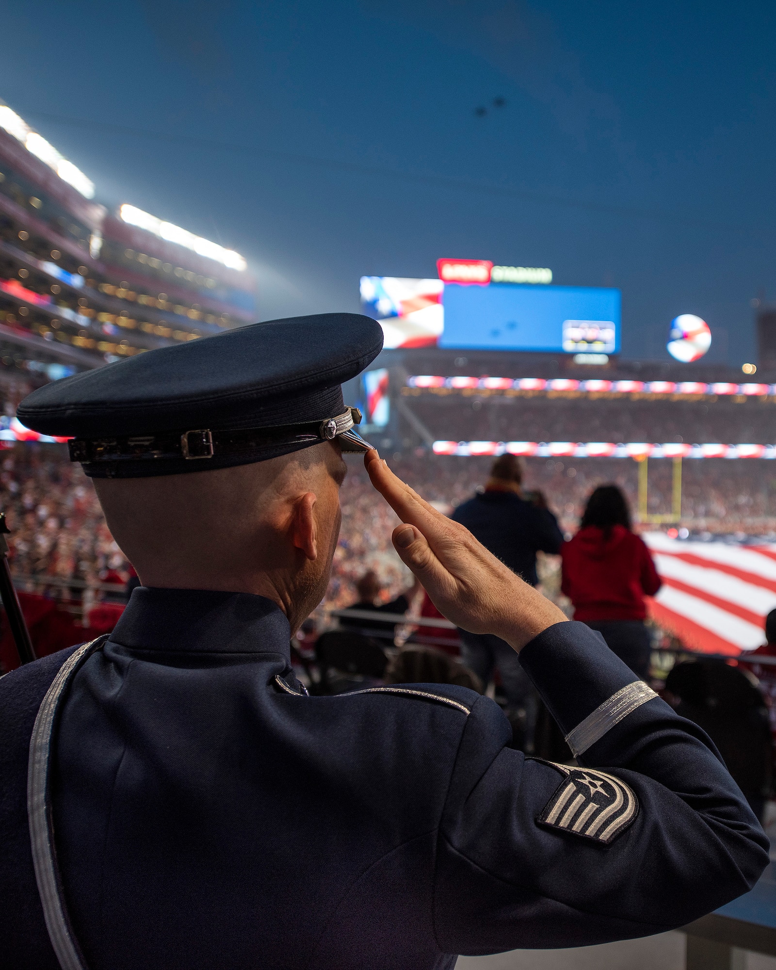 A musician with the U.S. Air Force Band of the Golden West from Travis Air Force Base, California, salutes during pregame activities of the San Francisco Forty-Niners and New York Giants Monday Night Football game at Levi’s Stadium in Santa Clara, California, Nov. 12, 2018. The band performed in honor of Veterans Day and to support the National Football League’s Salute to Service Campaign. (U.S. Air Force photo by Louis Briscese)