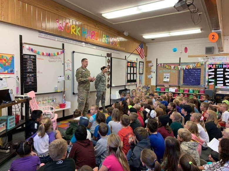 Tech. Sgt. Philip Pinillos, 419th Cyber Flight, and Airman Brianne Chapman, 419th Maintenance Group, speak to students at West Point Elementary about the Air Force Reserve during a Veterans Day event Nov. 9