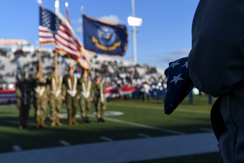 Retired U.S. Navy Petty Officer 2nd Class Brian Graves holds the American flag before a football game at Old Dominion University in Norfolk, Virginia, Nov. 10, 2018.