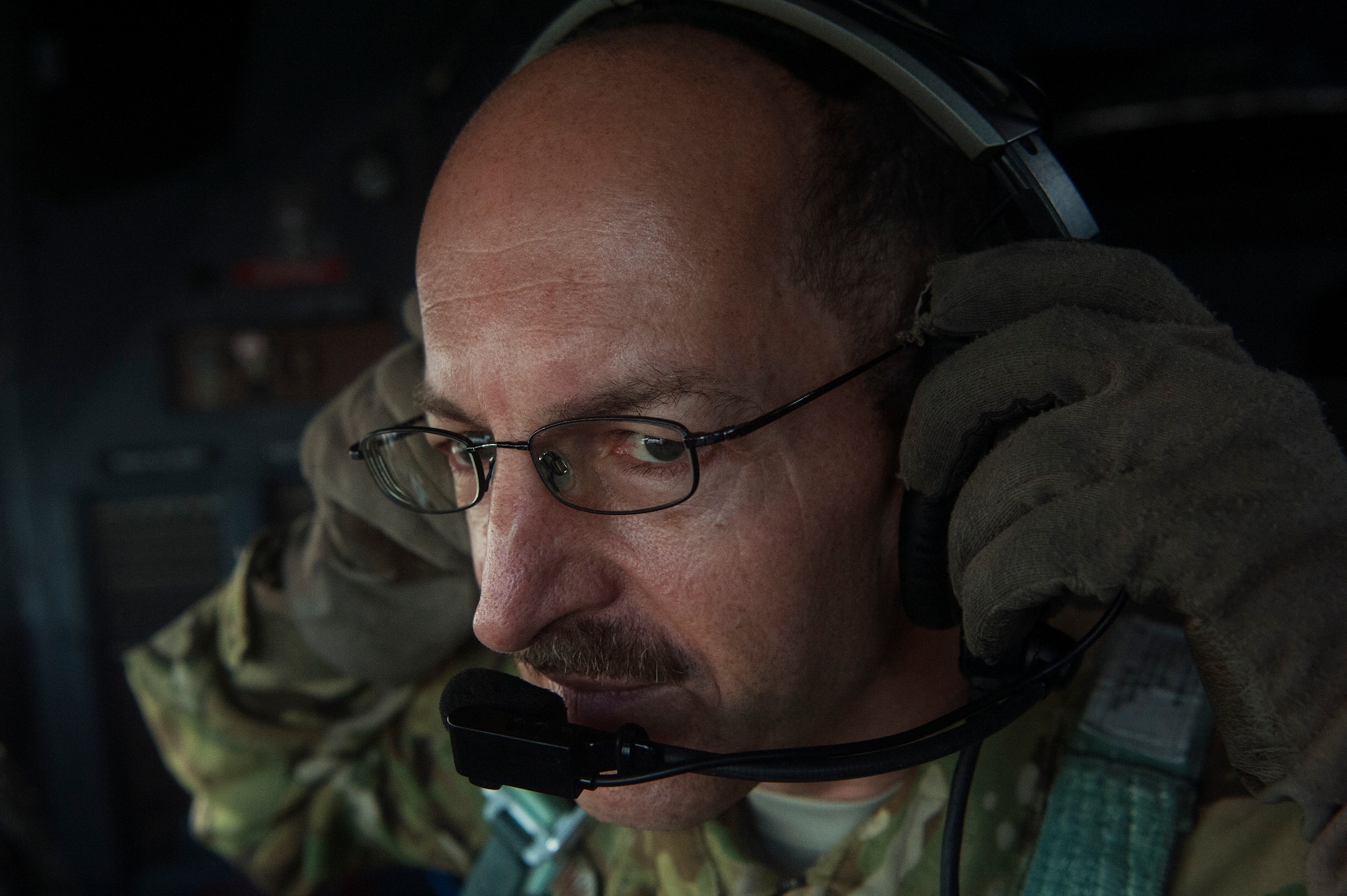 U.S. Air Force Chief Master Sgt. Kenneth Kunkel, 746th Expeditionary Airlift Squadron C-130 Hercules flight engineer, checks his headset during a C-130 Hercules pre-flight inspection Nov. 13, 2018, at Al Udeid Air Base, Qatar. Kunkel reached 10,000 flying hours Oct. 6, 2018, a number considered prestigious amongst military aviators. (U.S. Air Force photo by Tech. Sgt. Christopher Hubenthal)