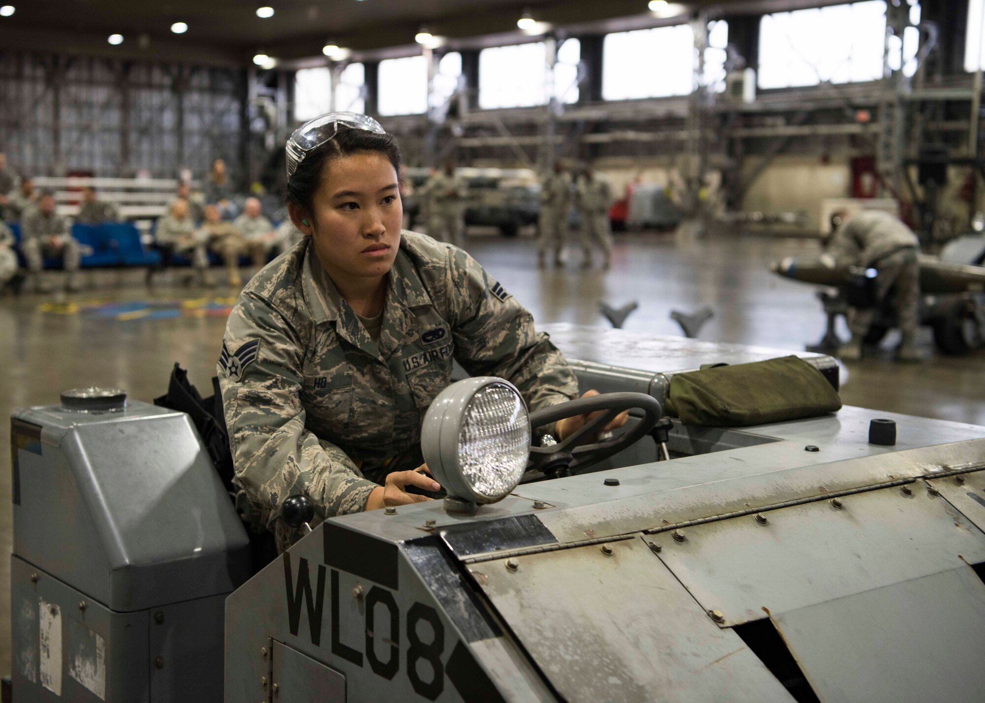U.S. Air Force Senior Airman Jessica Ho, a 14th Aircraft Maintenance Unit load crew member, drives a MJ-1 standard lift truck during the third quarter load competition at Misawa Air Base, Japan, Nov. 9, 2018. Airmen use this rear-steered transportation device to align bomb lugs into the bomb rack hooks on F-16 Fighting Falcons, requiring absolute concentration and attention to detail to prevent aircraft damage while racing against the clock. (U.S. Air Force photo by Airman 1st Class Collette Brooks)