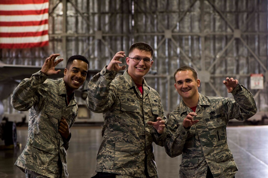 U.S. Air Force Senior Airman Travonne Lindsay, left, and Airman 1st Class Cody Wilson, center, both weapons load crew members, and Staff Sgt. Branden Goodrich, a load crew team chief, all with the 13th Aircraft Maintenance Unit, pose for a photo during the third quarter load competition at Misawa Air Base, Japan, Nov. 9, 2018. During the competition, Airmen raced against the clock to see which team could efficiently and accurately load munitions onto an F-16 Fighting Falcon. (U.S. Air Force photo by Airman 1st Class Collette Brooks)