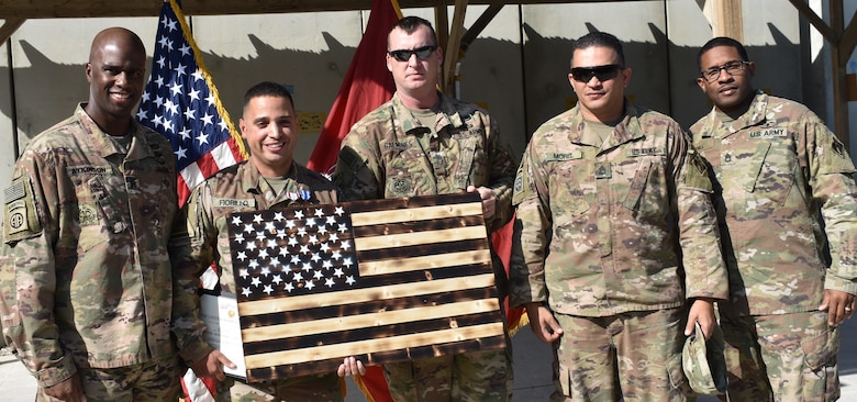 Staff Sgt. Vincent Fiorillo is presented with a symbol of his patriotism from his fellow Soldiers deployed in support of Operation Freedom’s Sentinel with the USACE Afghanistan District.