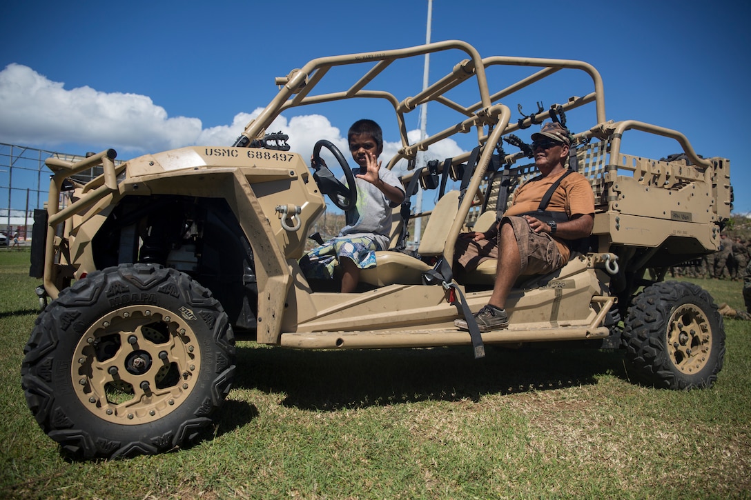 Tinian residents sit inside a military vehicle after a ceremony marking the end of the 31st Marine Expeditionary Unit’s mission as part of the U.S. Defense Support of Civil Authorities relief efforts on Tinian, Commonwealth of the Northern Mariana Islands, Nov. 14, 2018. Marines and Sailors with the 31st MEU and Combat Logistics Battalion 31 assisted the U.S. Federal Emergency Management Agency and local and civil authorities on Tinian to deliver aid to Tinians affected by Super Typhoon Yutu, which struck here Oct. 25 as the second strongest storm to ever hit U.S. soil. Marines and Sailors with the 31st MEU and CLB-31 arrived on Tinian Oct. 29-31 to lead relief efforts on Tinian in response to Yutu as part of Task Force-West. TF-W is leading the Department of Defense’s efforts to assist CNMI’s local and civil authorities provide critical assistance for citizens devastated by Yutu. The 31st MEU, the Marine Corps’ only continuously forward-deployed MEU, provides a flexible force ready to perform a wide-range of military operations across the Indo-Pacific region.