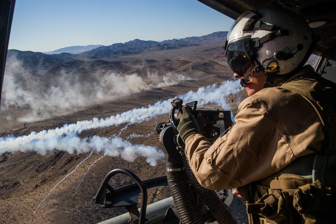 U.S. Marine Lance Cpl. Joseph Krieter observes his surroundings from a UH-1Y Venom during a live fire range as part of Integrated Training Exercise at Marine Corps Air Ground Combat Center Twentynine Palms, California, Nov. 9, 2018. ITX is a large-scale, combined-arms training exercise intended to produce combat-ready forces capable of operating as an integrated Marine air-ground task force. Krieter is a crew chief with Marine Light Attack Helicopter Squadron 167.