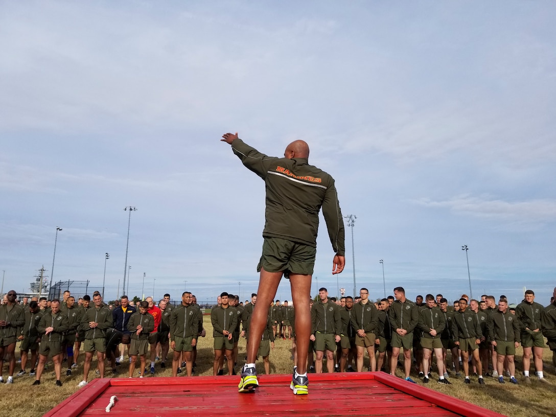 U.S. Marine Corps Sgt. Maj. Adam J. Moore, sergeant major of Headquarters and Service Battalion, U.S. Marine Corps Forces Command, leads Marines and Sailors during warm up exercises as part of the MARFORCOM 243rd Marine Corps birthday run Nov. 8, 2018, at Naval Station Norfolk, Norfolk, Virginia. The run was held in celebration of the 243rd Marine Corps birthday and to commemorate the 100 year anniversary of the end of World War I.  (U.S. Marine Corps photo by Sgt. Jessika Braden/Released)