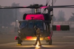U.S. Army Sgt. Greg Fernandez, a UH-60M Black Hawk helicopter crew chief, works outside of the helicopter after landing, Nov. 11, 2018, at Sacramento Mather Airport in Mather, California. The helicopter is one of the first M-model UH-60s assigned to the California Army National Guard. The aircraft and crew traveled from Joint Forces Training Base, Los Alamitos, in Southern California to support state agencies battling the deadly Camp Fire in Northern California.