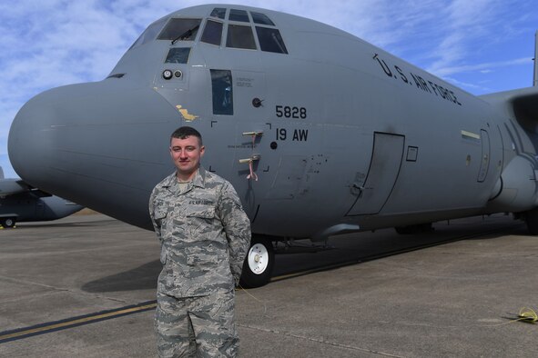 Man stands in front of plane.