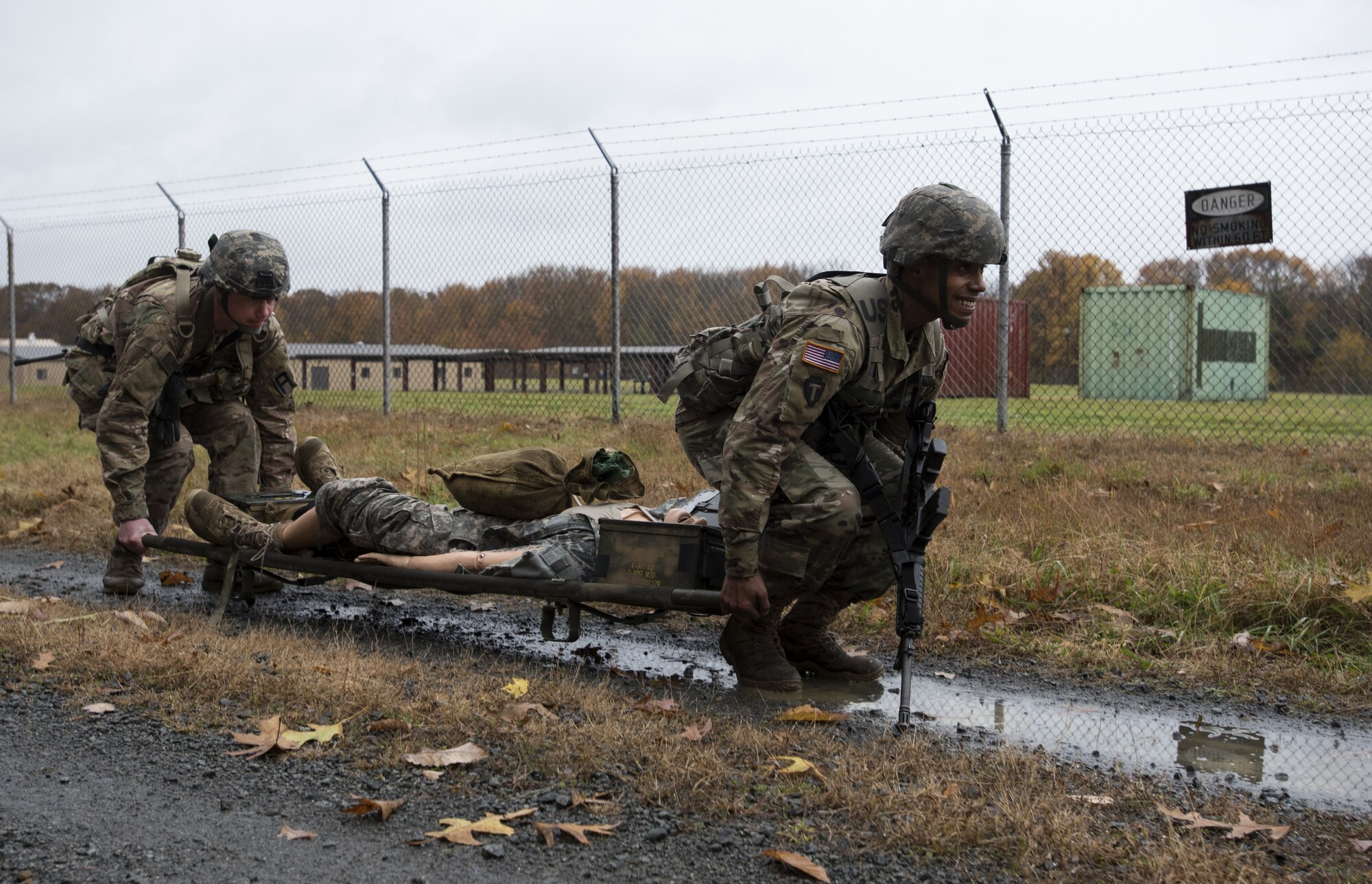 U.S. Marine Corps Staff Sgt. Lester Dickerson, Marine Light Attack Helicopter Squadron 773 aerial observer, and Lance Cpl. Cameron A. Schimmel, Marine Aircraft Group 49 aviation supply specialist, lift a weighted stretcher during the relay race portion of the 2018 Service Member of the Year Competition on Joint Base McGuire-Dix-Lakehurst, New Jersey, Nov. 5, 2018. The race required the competitors to team up and transport approximately 300 pounds over .8 miles under an hour. (U.S. Air Force photo by Airman 1st Class Ariel Owings)