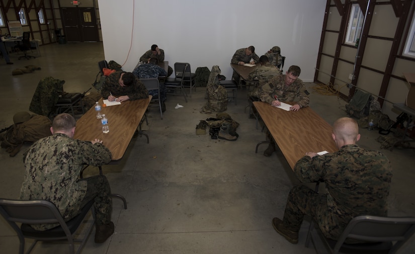 Service members take a written test during the 2018 Service Member of the Year Competition on Joint Base McGuire-Dix-Lakehurst, New Jersey, Nov. 5, 2018. Each challenge was comprised of the Defense Departments vision of what military members should be capable of, regardless of their branch of service. (U.S. Air Force photo by Airman 1st Class Ariel Owings)
