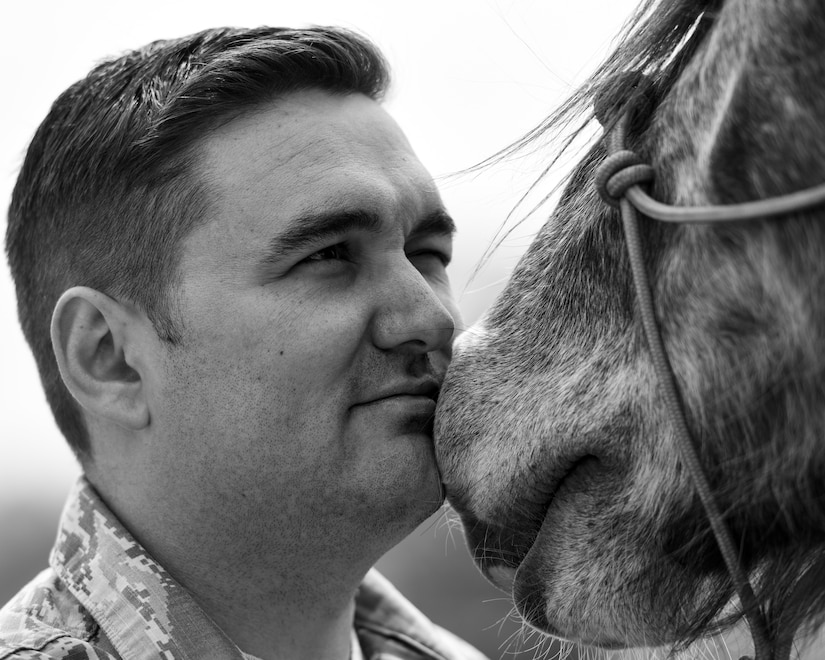 U.S. Air Force Staff Sgt. Cody Wisley, 83rd Network Operations Squadron boundary protection supervisor, speaks to his horse, Steel, at Joint Base Langley-Eustis, Virginia, April 12, 2018.