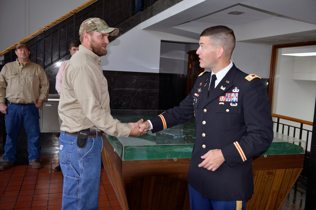 Lt. Col. Cullen Jones, Nashville District commander, congratulates Cade Barnes, maintenance worker, at Dale Hollow Power House for his selection as the Nashville District’s Employee of the Month for September 2018.