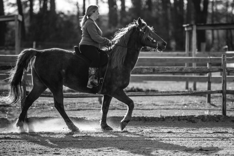 Tiffany Wisley, Langley Saddle Club head feeder, rides her horse Spooks at the stables on Joint Base Langley-Eustis, Virginia, April 11, 2018.